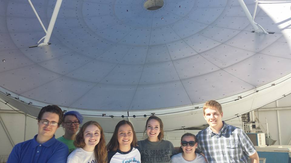 University of Arizona Steward Observatory undergraduate students involved in the radio astronomy project stand in front of the ARO Telescope.